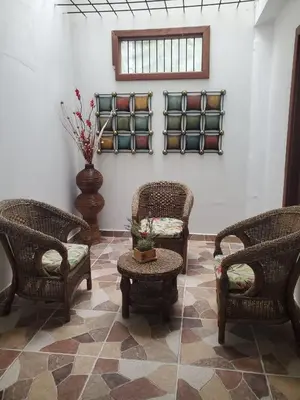 a room with wicker chairs and a table at Rosita 3 in Jardin