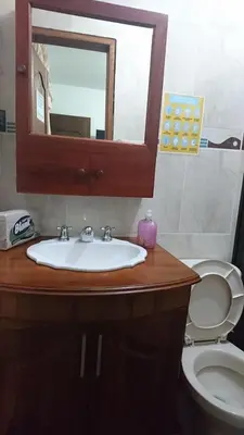 a bathroom with a sink and a toilet and a mirror at Rosita 3 in Jardin