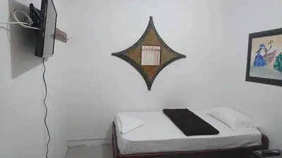a bedroom with a bed and a mirror on the wall at Rosita 3 in Jardin