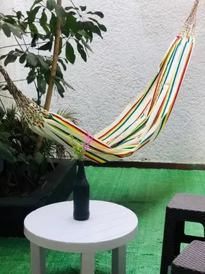 a hammock sitting on top of a white table at Casa Egos Pop Laureles in Medellín