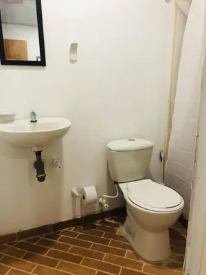 a bathroom with a toilet and a sink at Casa Egos Pop Laureles in Medellín