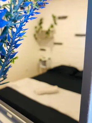 a reflection of a bedroom with a bed in a mirror at Casa Egos Pop Laureles in Medellín