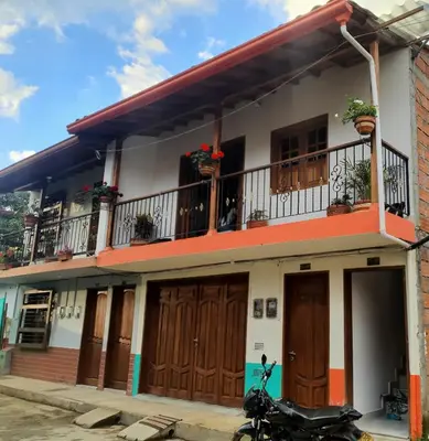 a house with a motorcycle parked in front of it at Villa del Socorro in Jardin