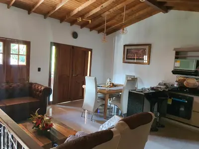 a living room with a couch and a table with chairs at Villa del Socorro in Jardin