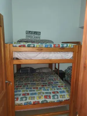a bunk bed with a comforter on top at Villa del Socorro in Jardin