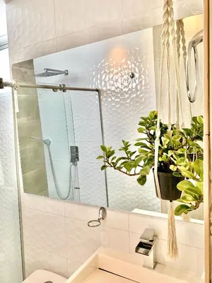 a bathroom with a glass shower and a plant at Hermoso Apartasol San Jeronimo in San Jerónimo