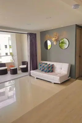 a living room with a white couch in a room at Hermoso Apartasol San Jeronimo in San Jerónimo
