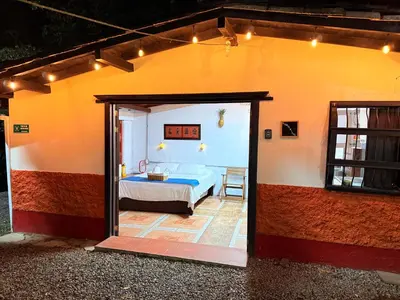 a bedroom in a house with a bed at Compostela cabaña privada (private cabin for rent) in Jardin
