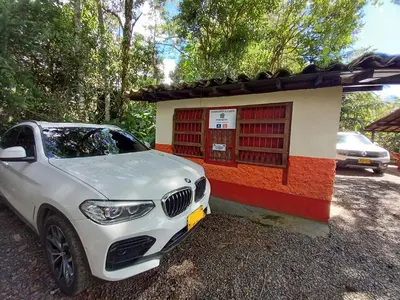 a white car parked in front of a building at Compostela cabaña privada (private cabin for rent) in Jardin