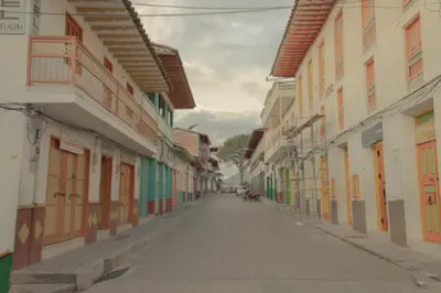 an empty street in a town with colorful buildings at Hotel Felicina in Jericó
