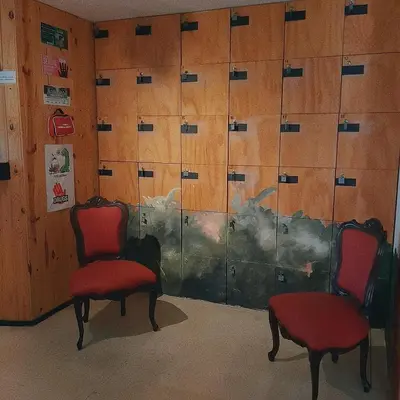 two red chairs in front of a glass door at Cloud9 Hostel in Medellín