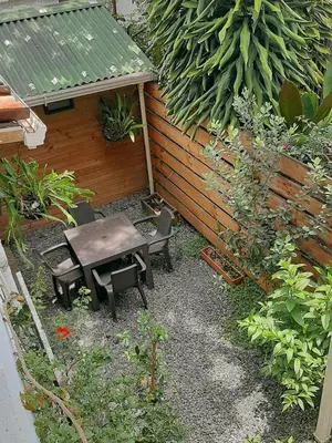 a small garden with a table and a bench at Cloud9 Hostel in Medellín