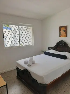 a bedroom with a large bed and a window at Cloud9 Hostel in Medellín