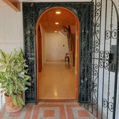 an entrance to a hallway with a black gate at Cloud9 Hostel in Medellín