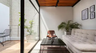 a living room with a couch and a table at Soy Local Primavera in Medellín