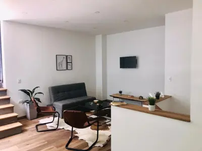 a living room with a couch and a table at Soy Local Primavera in Medellín
