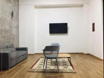 a living room with a chair and a couch at Soy Local Primavera in Medellín