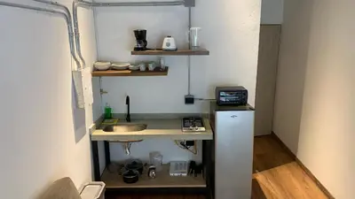 a small kitchen with a sink and a refrigerator at Soy Local Primavera in Medellín