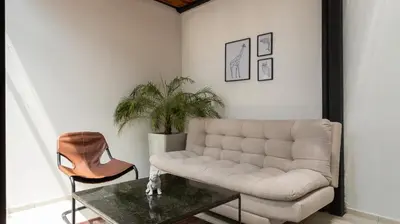 a living room with a couch and a table at Soy Local Primavera in Medellín
