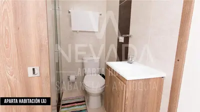 a bathroom with a toilet and a sink and a shower at NevadaLofts in Sabaneta