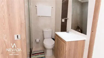 a bathroom with a toilet and a sink and a shower at NevadaLofts in Sabaneta