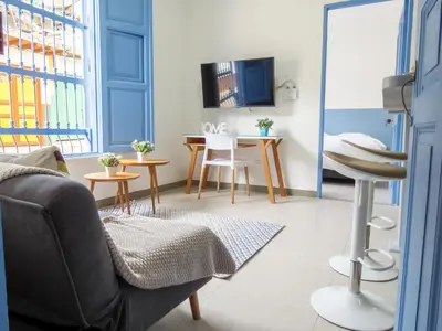 a living room with a couch and a table at Hotel Azulado Jericó in Jericó
