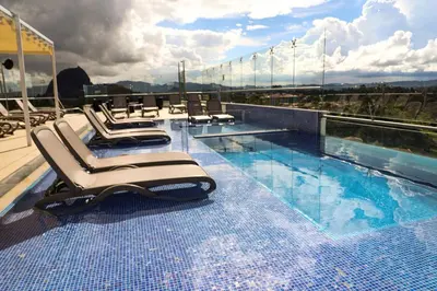 a swimming pool on the roof of a building at Hotel Santorini in Guatapé