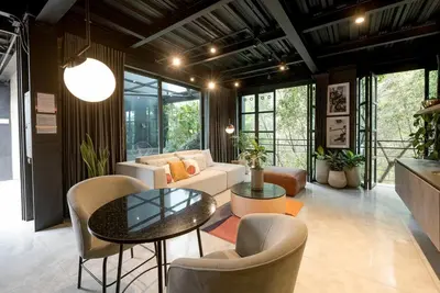 a living room with a couch and a table and chairs at Meridiano Apartments in Medellín