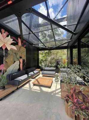 a patio with couches and a lot of plants at Meridiano Apartments in Medellín