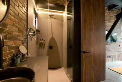 a bathroom with a shower with a glass door at Meridiano Apartments in Medellín
