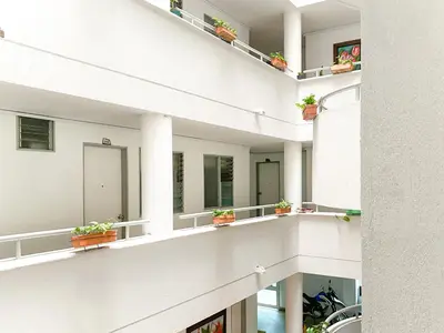 a building with potted plants on balconies at Hotel Plaza Mayor Itagui in Itagüí