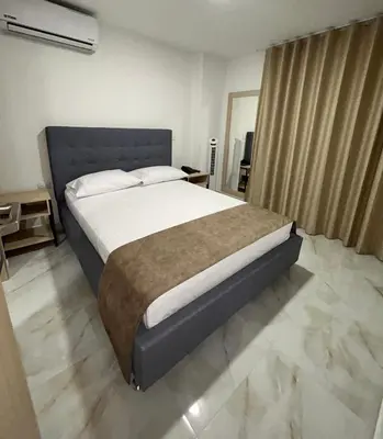a bedroom with a large bed in a room at Hotel Plaza Mayor Itagui in Itagüí