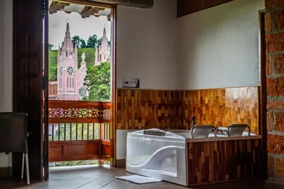 a bathroom with a toilet in a room with a window at Hotel Santa Laura in Jericó