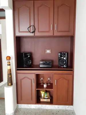 a wooden cabinet with two microwaves and two cameras at Hotel Mirador Santana in Anserma