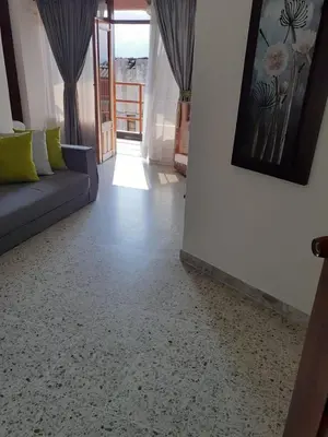 a living room with a couch and a painting on the wall at Hotel Mirador Santana in Anserma