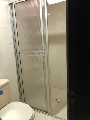 a shower stall in a bathroom with a toilet at Hotel Ecosuite Quibdó in Quibdó