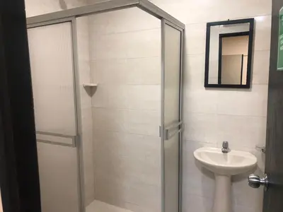 a bathroom with a shower and a sink at Hotel Ecosuite Quibdó in Quibdó