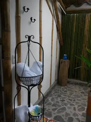a room with a hanging chair in a room at Hacienda Guayabal in Chinchiná