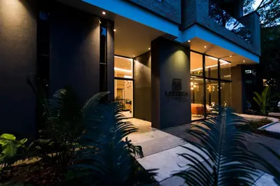 a house with plants in front of it at night at Lettera Hotel in Medellín