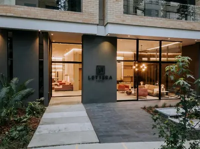 a lobby of a building with a lot of windows at Lettera Hotel in Medellín
