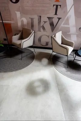 two chairs in a room with a wall at Lettera Hotel in Medellín