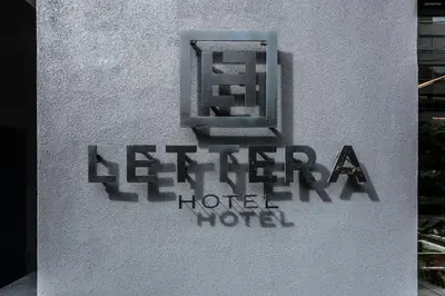 a sign on the side of a hotel at Lettera Hotel in Medellín