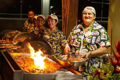 a group of people standing around a buffet of food at Hosteria Guaracú in San Jerónimo