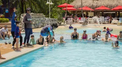 a group of people in a swimming pool at Hosteria Guaracú in San Jerónimo