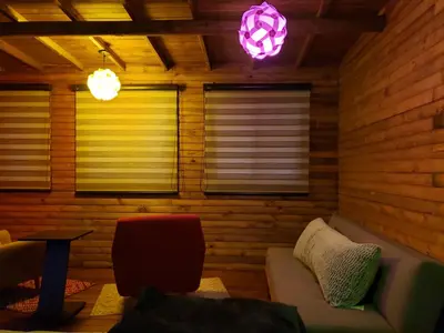 a living room with a couch and two windows at La Zenerchi in Rionegro