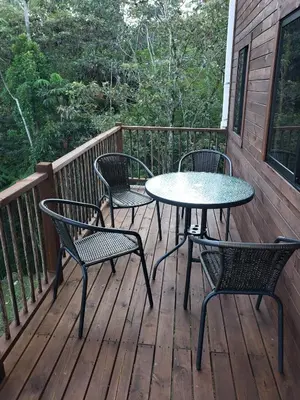 a patio with two tables and chairs on a deck at La Zenerchi in Rionegro