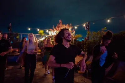 a group of people dancing at a party at night at Viajero Medellín Hostel in Medellín