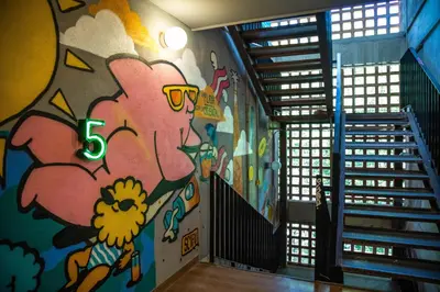a hallway with a mural on the wall at Viajero Medellín Hostel in Medellín