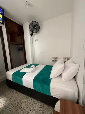 a bedroom with a bed with a swan on it at Roomies House By Rincon in Medellín