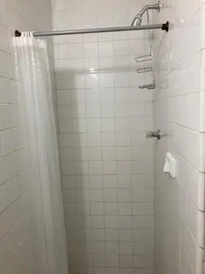 a bathroom with a shower with a shower curtain at Roomies House By Rincon in Medellín